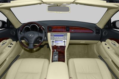 Luxury interior with wood trim, beige leather seats, and advanced dashboard controls