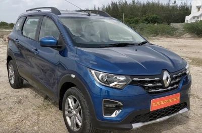 Front view of a blue compact SUV with LED headlights and grille.