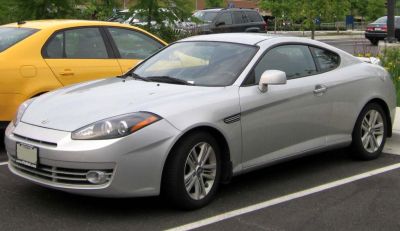 Silver coupe with sleek front fascia and aerodynamic side profile.