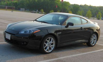 Sleek black sporty coupe with alloy wheels and smooth design