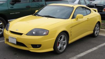 Yellow sports coupe with sleek headlights and alloy wheels