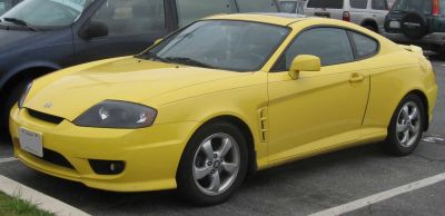 Yellow sporty coupe with front fog lights and alloy wheels