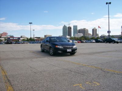 Front view of black coupe with distinctive headlights