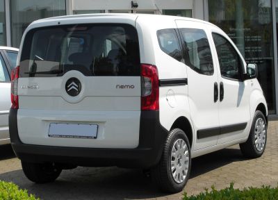 Rear and side view of compact van with sliding doors and large rear cargo door