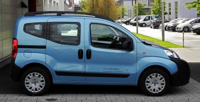 Small blue multipurpose vehicle side profile with sliding doors and large windows