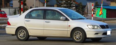 2000 model sedan with alloy wheels and clear headlights side view