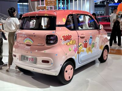Compact rear view with colorful cartoon-themed wrap and round taillights