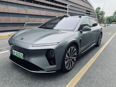 Aerodynamic grey electric sedan with striking LED headlights and unique wheel rims