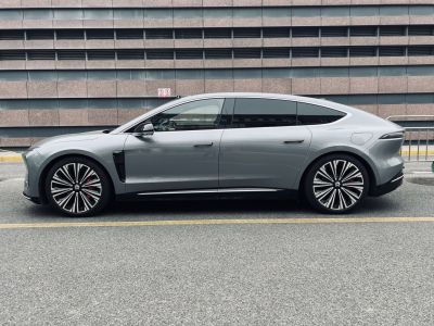 Side view of aerodynamic electric sedan with alloy wheels and flush door handles