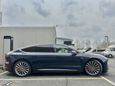 Sleek electric sedan with aerodynamic profile and multi-spoke alloy wheels