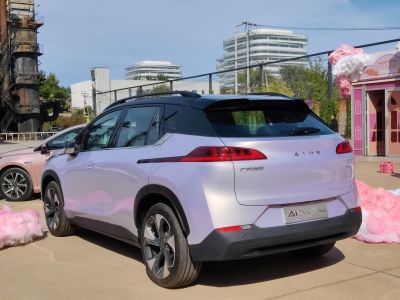 Rear view with sleek tail lights and black roof design