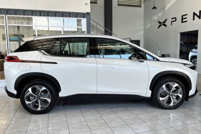 Side profile of a white electric SUV with modern alloy wheels and sleek design
