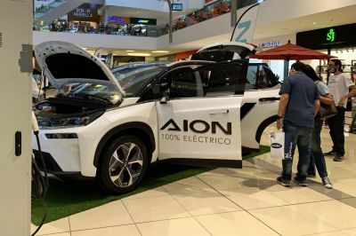Electric SUV with front and rear doors plus hood open at showroom