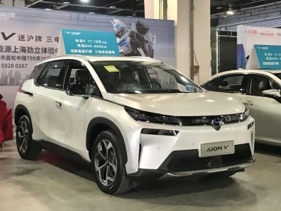 Front side view of a modern electric SUV with sleek headlights and aerodynamic design