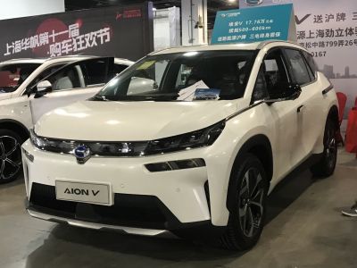 Futuristic LED headlights and sleek white electric SUV body