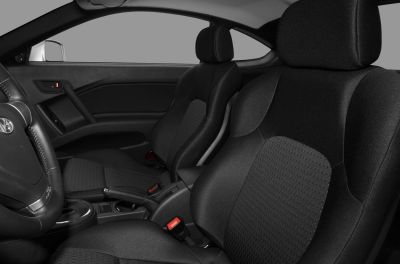 Car interior showing front seats with fabric upholstery
