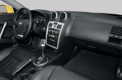 Car interior dashboard with manual gear shift and circular air vents