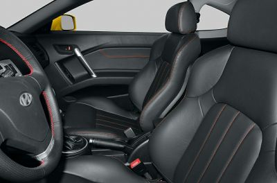 Black leather car seats with red stitching and leather-trimmed steering wheel