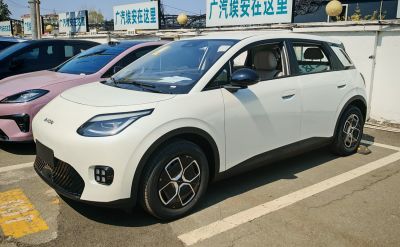 Front side view of a modern compact electric SUV with distinctive headlights and unique wheels