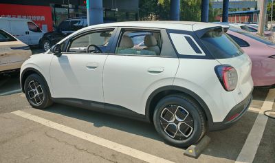 White compact SUV side profile with geometric wheels and black lower trim