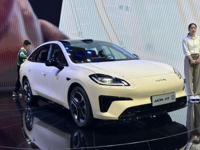 Front and side view of sleek electric sedan with modern headlights