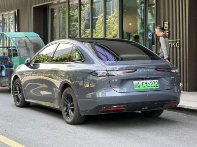 Sleek rear view with narrow tail lights and tinted windows