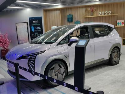 Electric vehicle with angular LED headlights and geometric wheel covers