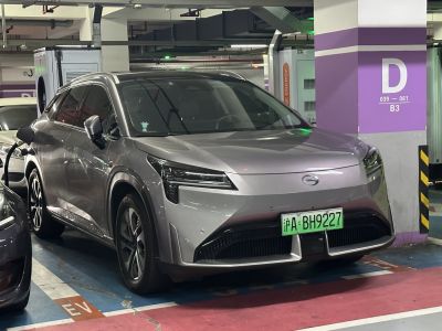 Electric SUV front view charging with sleek aerodynamic design and modern headlights.