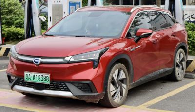Front and side view of red electric SUV with LED headlights and angled design