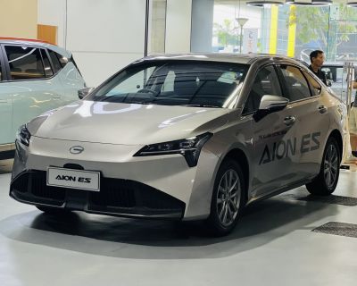 Sleek electric sedan front and side view with aerodynamic headlights