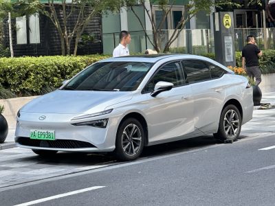 Sleek silver electric sedan with narrow LED headlights and aerodynamic profile