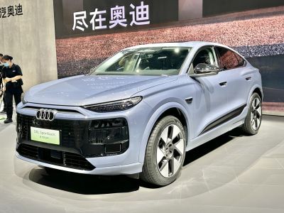 Front angle view of a modern electric coupe-SUV with sporty design and LED headlights.