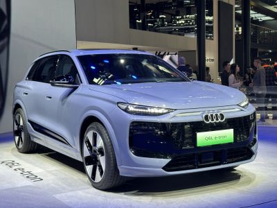 Front view of electric SUV with LED headlights and sleek grille