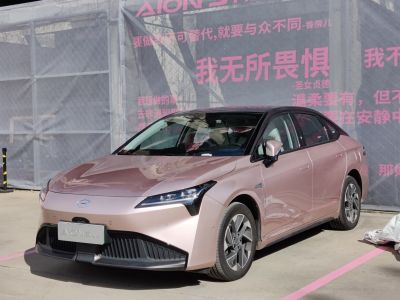 Front view with sharp headlights and aerodynamic design of an electric sedan