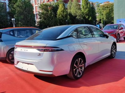 Rear view of sleek electric sedan with continuous LED taillights and aerodynamic styling