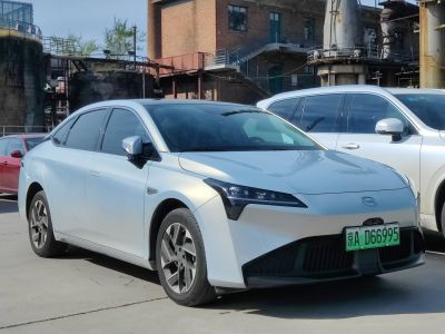 Silver electric sedan with sleek headlights and aerodynamic front design