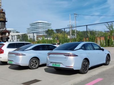 Rear view of two electric sedans with sleek aerodynamic tail lights.