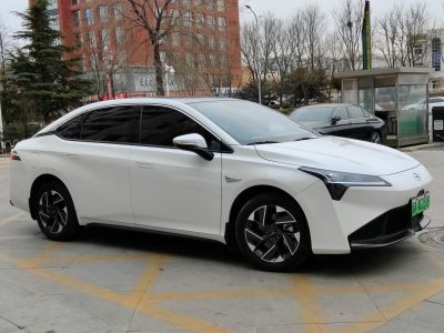 White electric sedan side profile with aerodynamic design and modern wheels