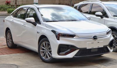 White sleek electric sedan with sharp headlights and aerodynamic front design