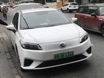White electric sedan front with sleek headlights and aerodynamic design