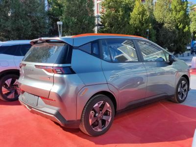 Electric crossover rear view with roof spoiler and futuristic taillights