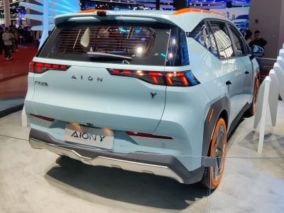 Rear view of electric SUV with LED taillights and orange-accented wheels and roof