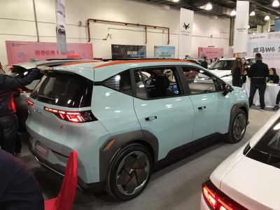Angular LED rear lights and futuristic wheel design on electric compact SUV.