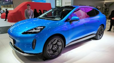 Blue electric SUV front three-quarter with LED headlights and aerodynamic design
