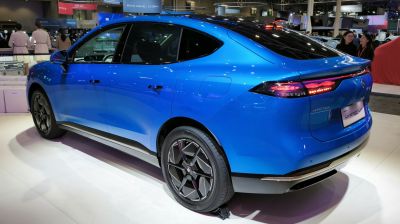 Sleek side profile and illuminated rear lights of a modern electric vehicle