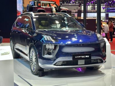 Sleek front view of electric SUV with modern headlights and aerodynamic design.