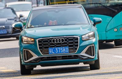 Front view showing honeycomb grille and LED headlights with turn signals on