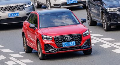 Red compact SUV with sporty front grille and LED headlights