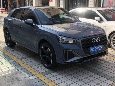 Sporty front grille and alloy wheels with tinted windows on blue compact SUV