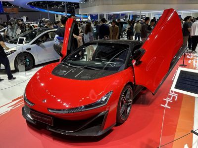 Red hypercar with butterfly doors and carbon fiber hood